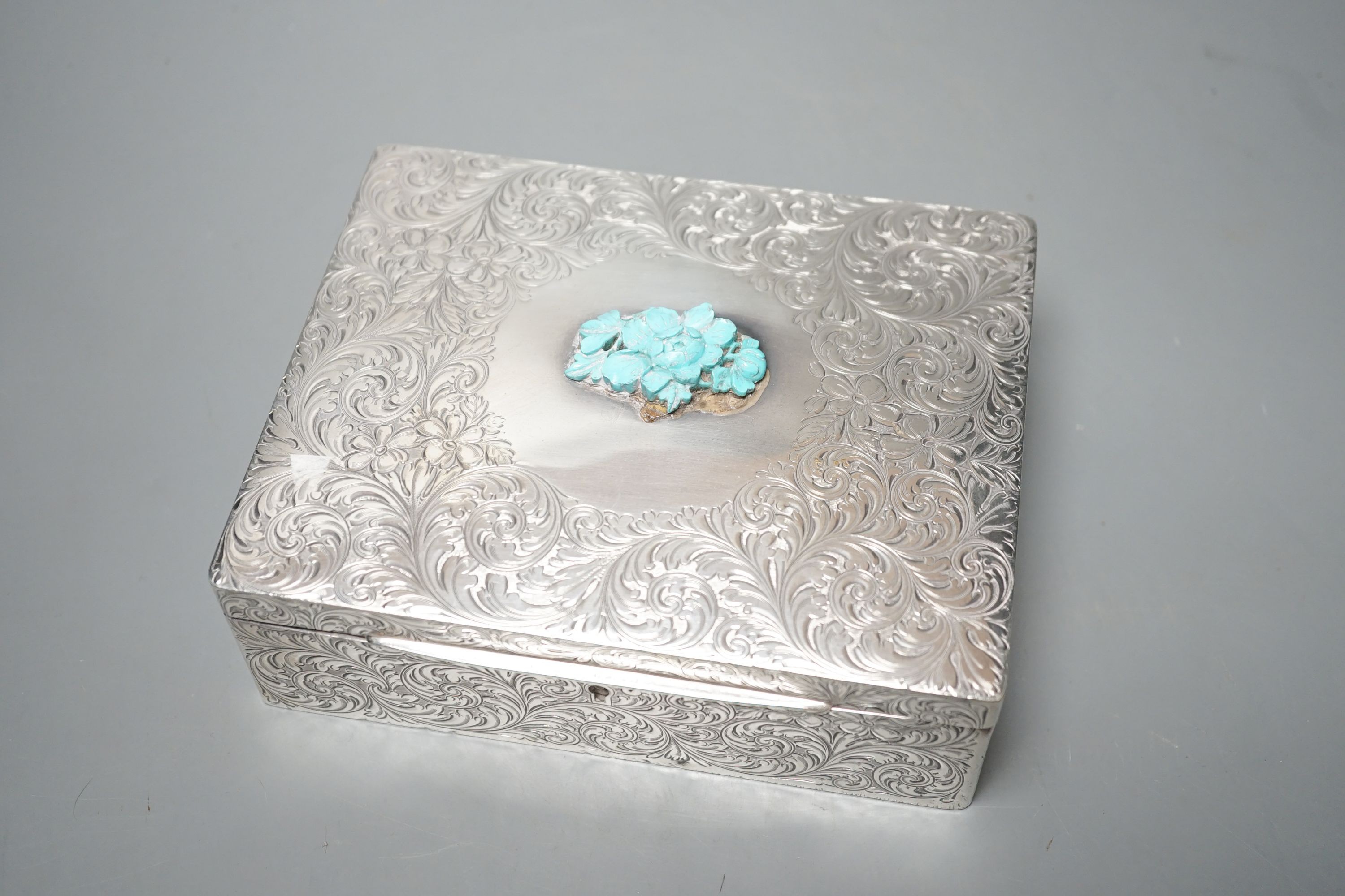 An engraved sterling rectangular box, with later added foliate mount, 16cm.